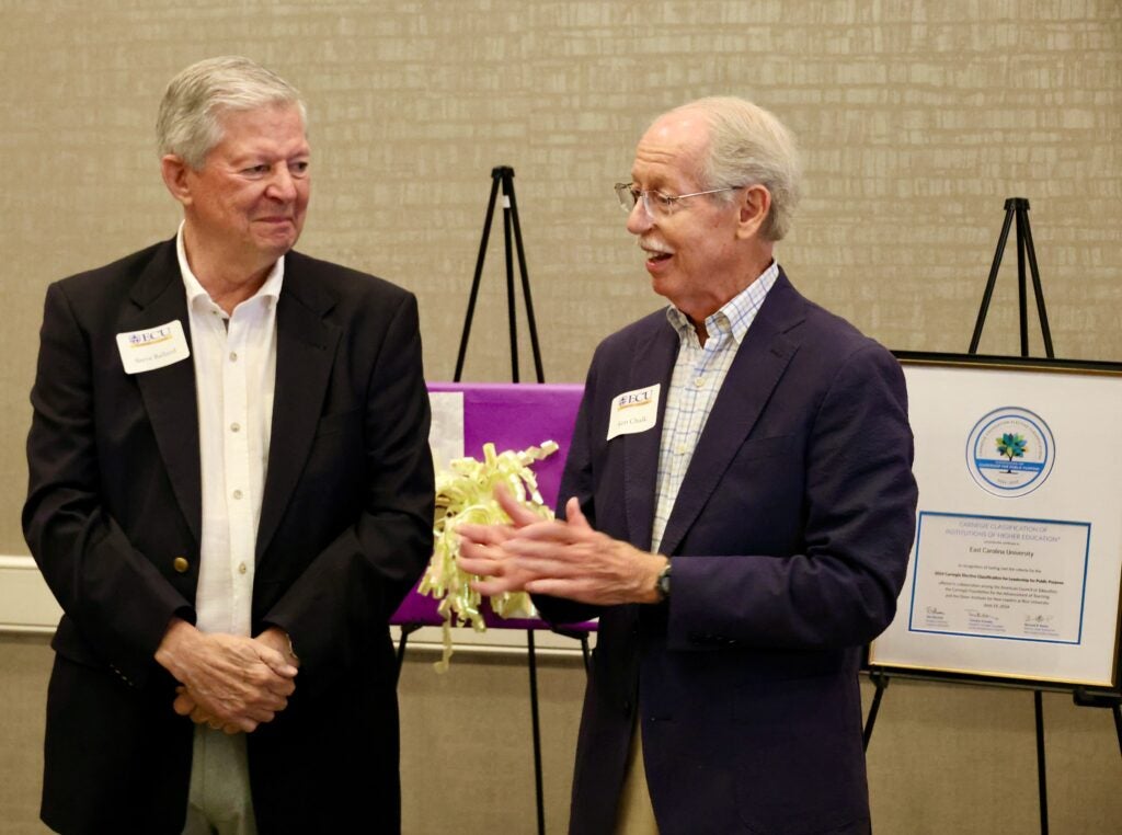 Ken Chalk speaking while Steve Ballard listens