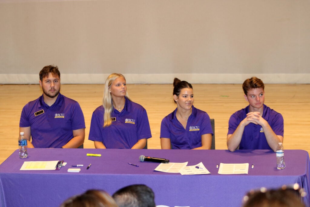 honors ambassadors sit at a purple table