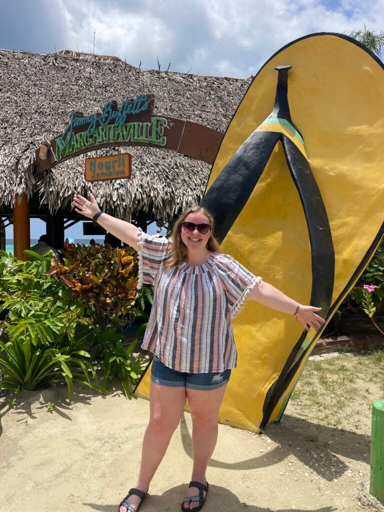 Madison Wood standing in front of a giant flipflop statue at the Jamaica Margaritaville