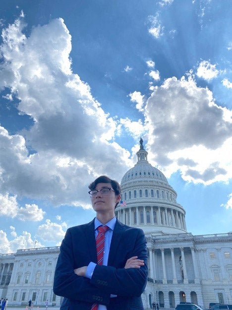 Javier stands in front of the Capitol Building