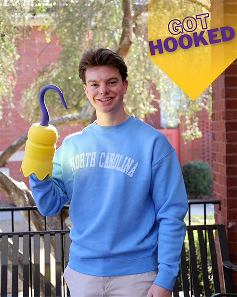 male student holding 3D printed hook