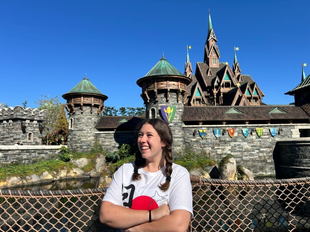 female student standing in front of castle