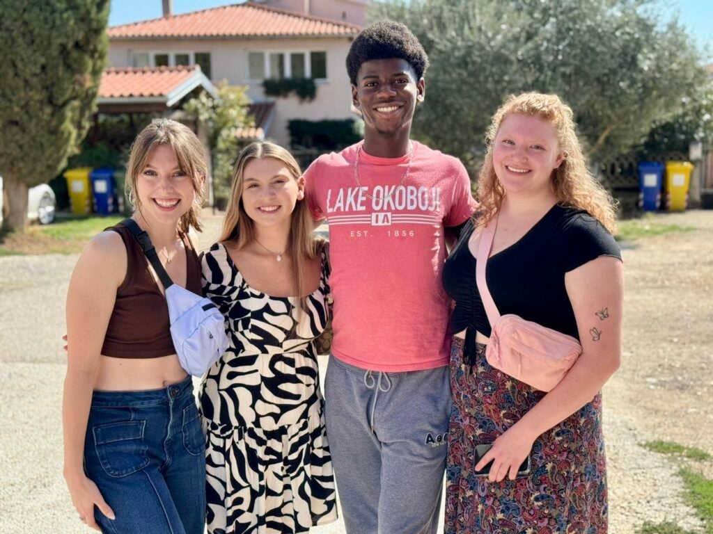 Group of students standing together in front of a house in Croatia