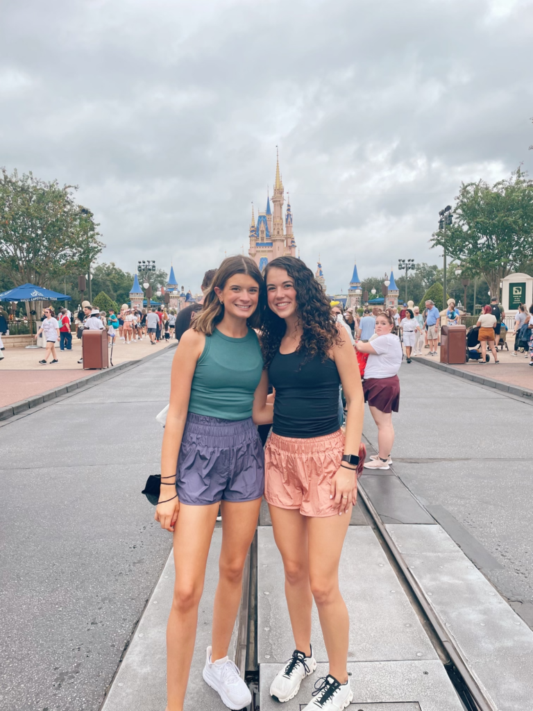 Maggie Baile and Carmen Walker in Disney in front of the Cinderella castle